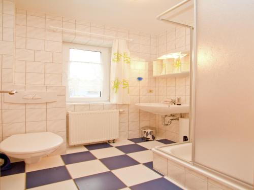 a bathroom with a toilet and a sink at Spacious appartment in Wilhelmshof near Lake in Wilhelmshof