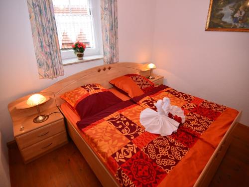 a bedroom with a large bed with a dress on it at Ferienhaus in der Nähe der Skipiste in Stadlern