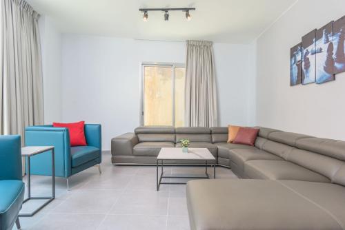 a living room with a couch and two chairs at Grey - Elegant Apartments in Awkar in Dbayeh