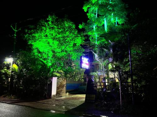a building with green lights on it at night at Neon Nirvana in Varkala