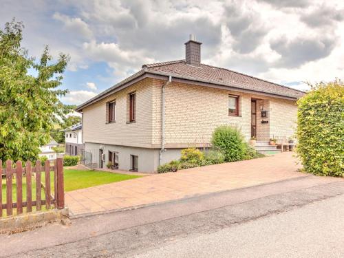 a white house with a fence in front of it at Sonnige Wohnung in Bad Driburg mit Garten in Bad Driburg