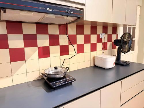 a kitchen counter with a pot on a stove at JR Homestay 141-3rd Mile House 3-6 Pax in Kuching