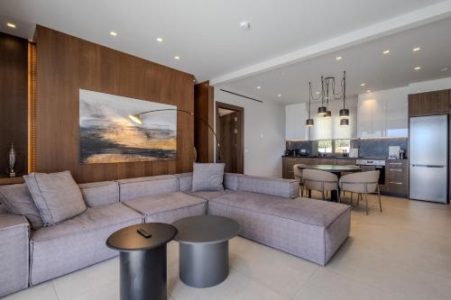 a living room with a couch and a kitchen at Maravilla Luxury Living in Kos Town