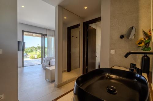 a bathroom with a black bath tub in a room at Maravilla Luxury Living in Kos Town