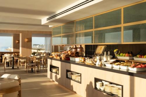 a kitchen with a counter with food on it at INNSiDE by Meliá Alicante Porta Maris in Alicante