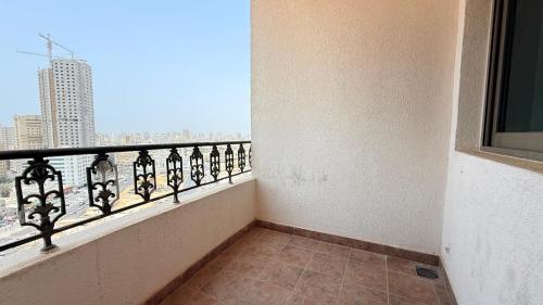 a balcony with a view of a city at Sunday Sharjah Aparthotel formerly Royal Tulip in Sharjah