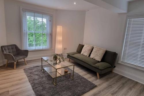a living room with a couch and a table at Tower House Apartments in Wakefield