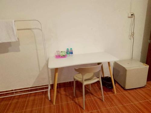 a white table and a chair in a room at GO INN Patong Beach Phuket - โกอินน์ ป่าตอง Pro in Patong Beach