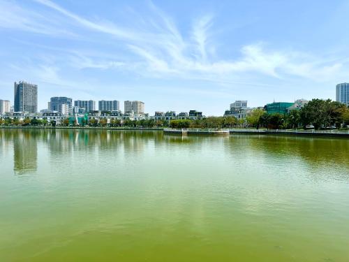a large body of water with a city in the background at Great 2bedroom Apt Quick To My Dinh And Marriott Hotel, 30 Minutes To Airport in Hanoi
