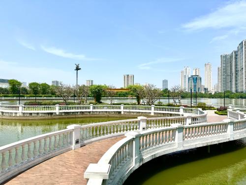 a bridge over a river with a city in the background at Great 2bedroom Apt Quick To My Dinh And Marriott Hotel, 30 Minutes To Airport in Hanoi