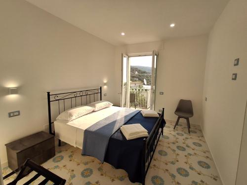 Un dormitorio con una cama y una ventana grande. en Rosa House, en Termini