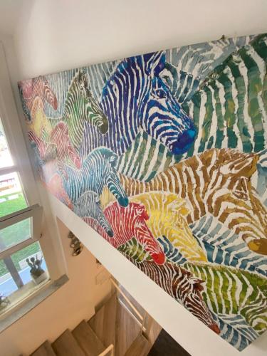 a painting of zebras on a wall at Villetta mare e pineta in Fregene
