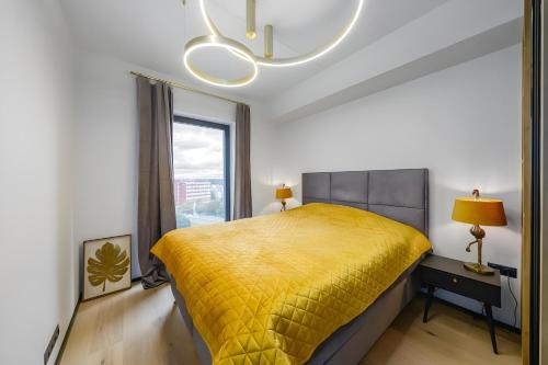 a bedroom with a yellow bed and a window at Luxury apartment, outstanding view, free parking in Tallinn