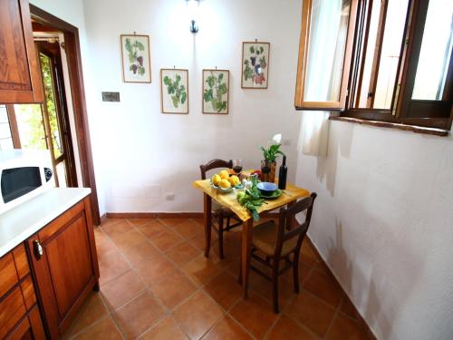 a kitchen with a table with a bowl of fruit on it at Cosy holiday home in Selci with swimming pool in Selci