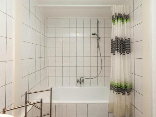 a white bathroom with a tub and a shower at House situated on a magnificent estate in Barvaux