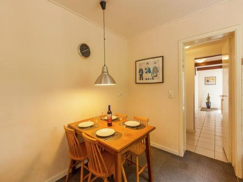 a dining room with a wooden table and chairs at House situated on a magnificent estate in Barvaux