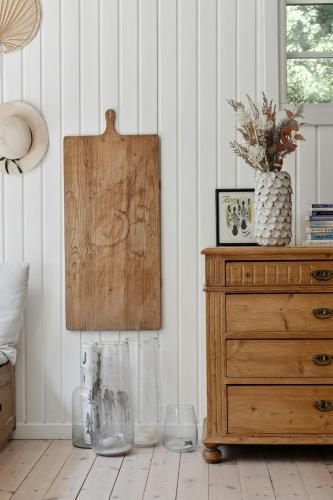 a room with a wooden dresser and a chest of drawers at Authentic Wooden House With Wild Garden in Grevinge