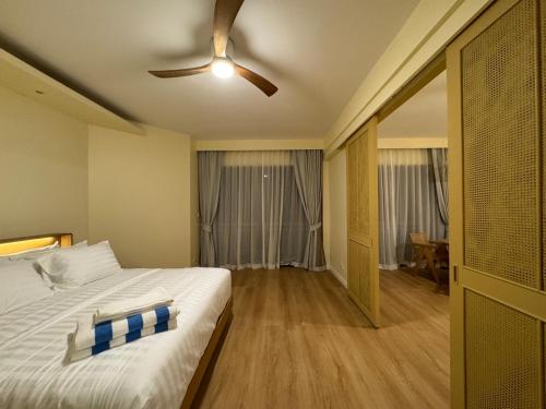 a bedroom with a bed and a ceiling fan at Cozy 1 BR Allamanda Laguna Phuket in Ban Nong Chaeng
