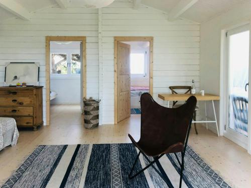 a room with a desk and a chair in it at Holiday Home With Fjord Views Near Kyndby in Jægerspris