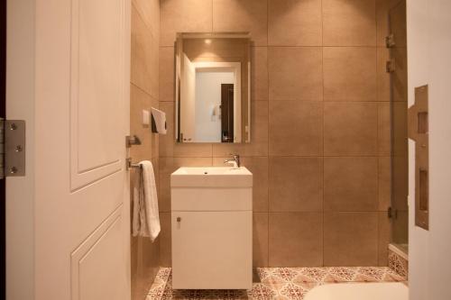 a bathroom with a sink and a mirror at Mar Mikhael Studios in Beirut