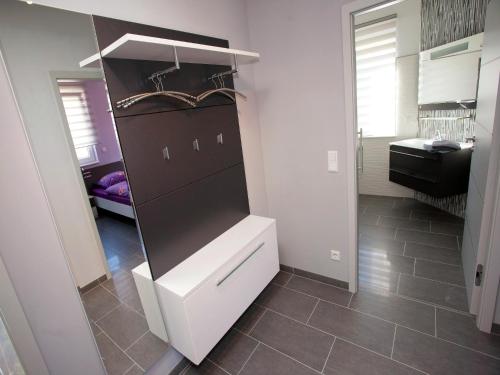 a kitchen with a white cabinet and a tile floor at Apartment Near Thuringian Forest in Tabarz