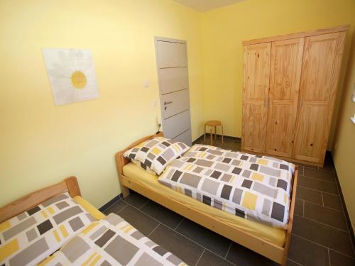 a bedroom with two beds and a closet at Apartment Near Thuringian Forest in Tabarz