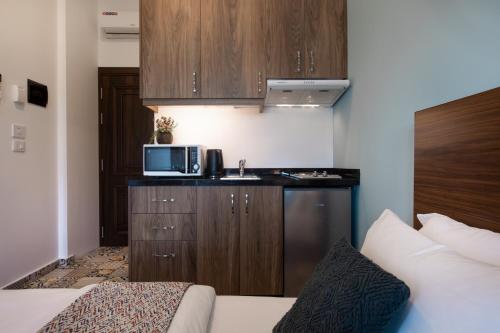 a small kitchen with a sink and a microwave at Mar Mikhael Studios in Beirut