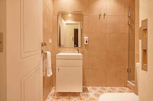 a bathroom with a sink and a mirror at Mar Mikhael Studios in Beirut