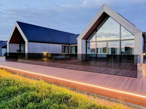 a house with a large glass facade at night at Modern Villa By Ballen Marina On Samsø in Ballen