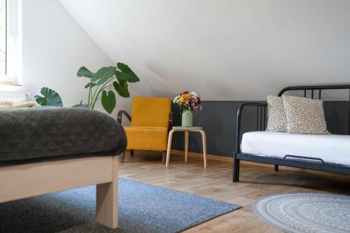a bedroom with a bed and a chair at Penzion Medové údolí in Čábuze
