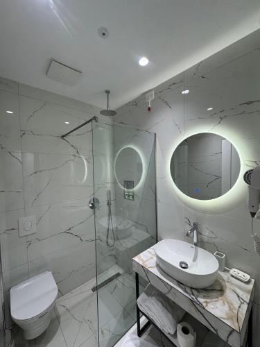 a bathroom with a toilet and a sink and a shower at Pegasus-In Hotel Borsh in Borsh