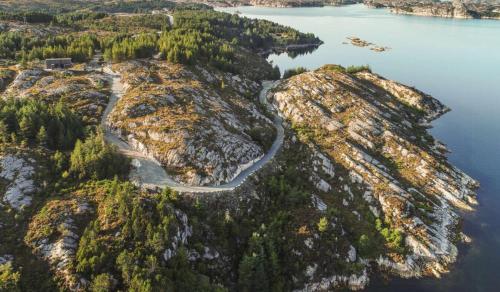 an aerial view of a rocky island in the water at Architect-Designed Cabin Panoramic View in Ervik