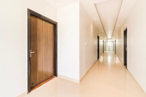 a corridor of a hospital hallway with a wooden door at Collection O Gaytri Palace in Lucknow