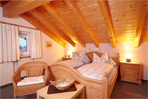 a bedroom with a bed and a table and a chair at Alp-Chalet in Bolsterlang