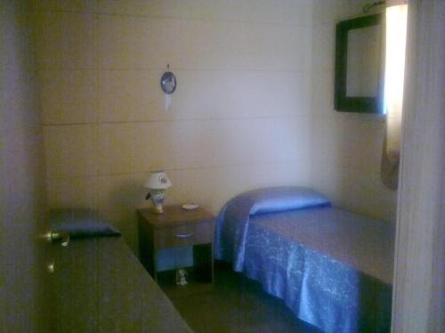a bedroom with two beds and a table and a clock at camping Venere in Granelli