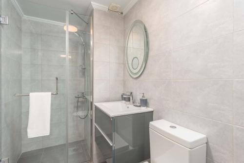 a bathroom with a toilet and a sink and a shower at Grey - Elegant Apartments in Awkar in Dbayeh