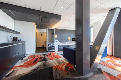 a living room with a couch and a room with at Fletcher Wellness-Hotel Leiden in Leiden