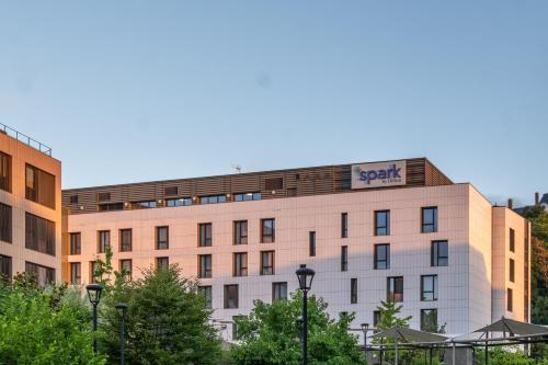 a building with a sap sign on top of it at Spark by Hilton Lyon Park Saone in Lyon