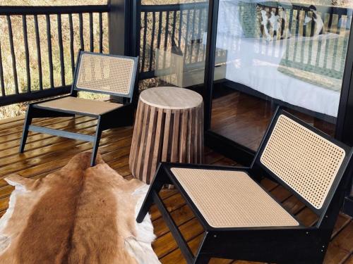two chairs and a table on a balcony at Edge of the Crater in Venterskroon