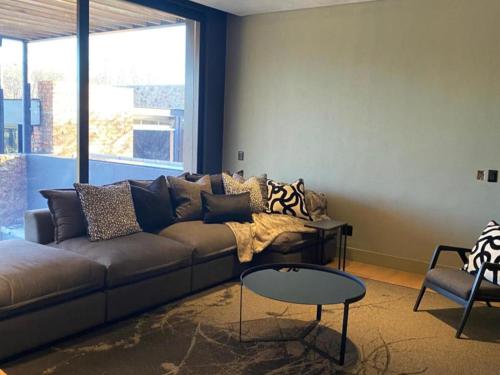 a living room with a couch and a table at Edge of the Crater in Venterskroon
