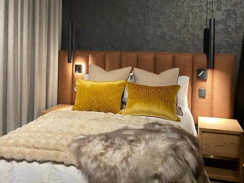 a bedroom with a large bed with yellow pillows at Edge of the Crater in Venterskroon