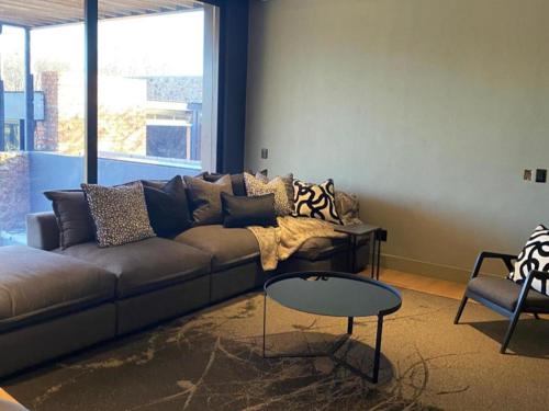 a living room with a couch and a table at Edge of the Crater in Venterskroon