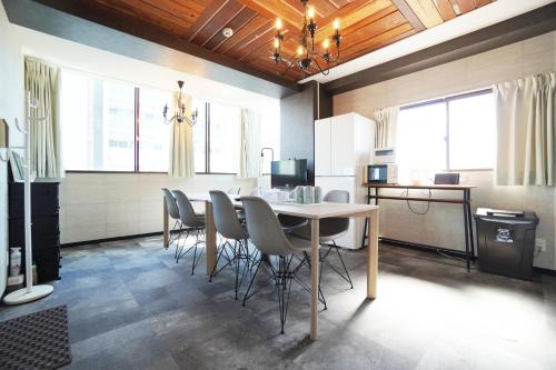 a dining room with a table and chairs at Nishiki-en in Osaka
