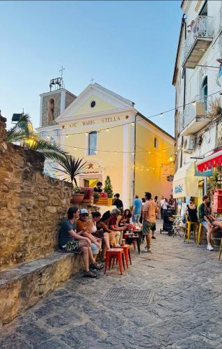 a group of people sitting outside of a building at Le Antiche Volte suite in Agropoli