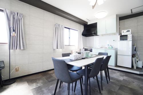 a kitchen with a table and chairs in a room at Nishiki-en in Osaka
