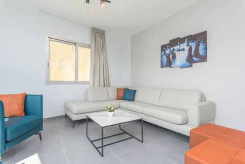 a living room with a couch and a table at Grey - Elegant Apartments in Awkar in Dbayeh