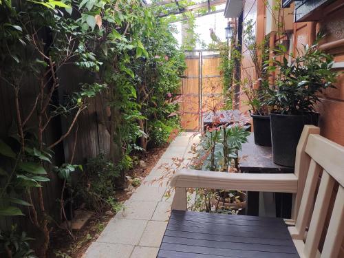 a small garden with a bench and plants at 藤紫FujiMurasaki Japanese classic House in Tokyo