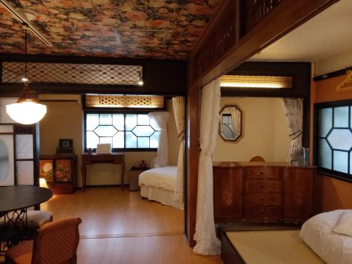 a room with a bedroom with a bed and windows at 藤紫FujiMurasaki Japanese classic House in Tokyo