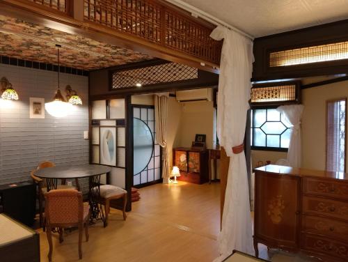 a room with a table and a dining room at 藤紫FujiMurasaki Japanese classic House in Tokyo