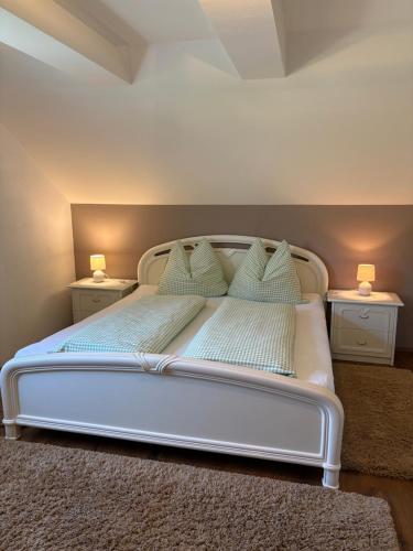 a bedroom with a white bed with two night stands at Gästezimmer Schupanez in Leutschach